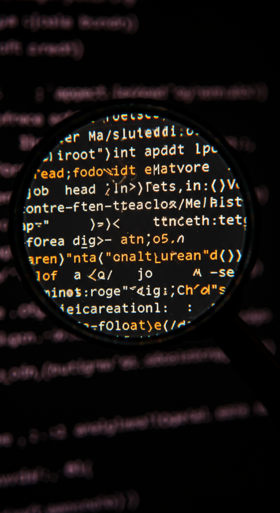 Magnifying glass highlighting HTML meta tag code on a computer screen.